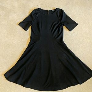 Fit and flare black dress with gold zipper detail